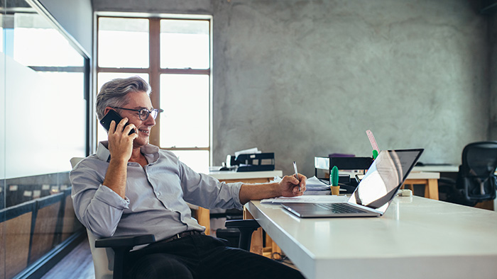 Man sitting at desk in grey office